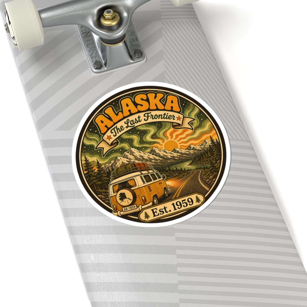 Round Alaska retro sticker on a silver notebook, with camper van, mountains, and Est. 1959