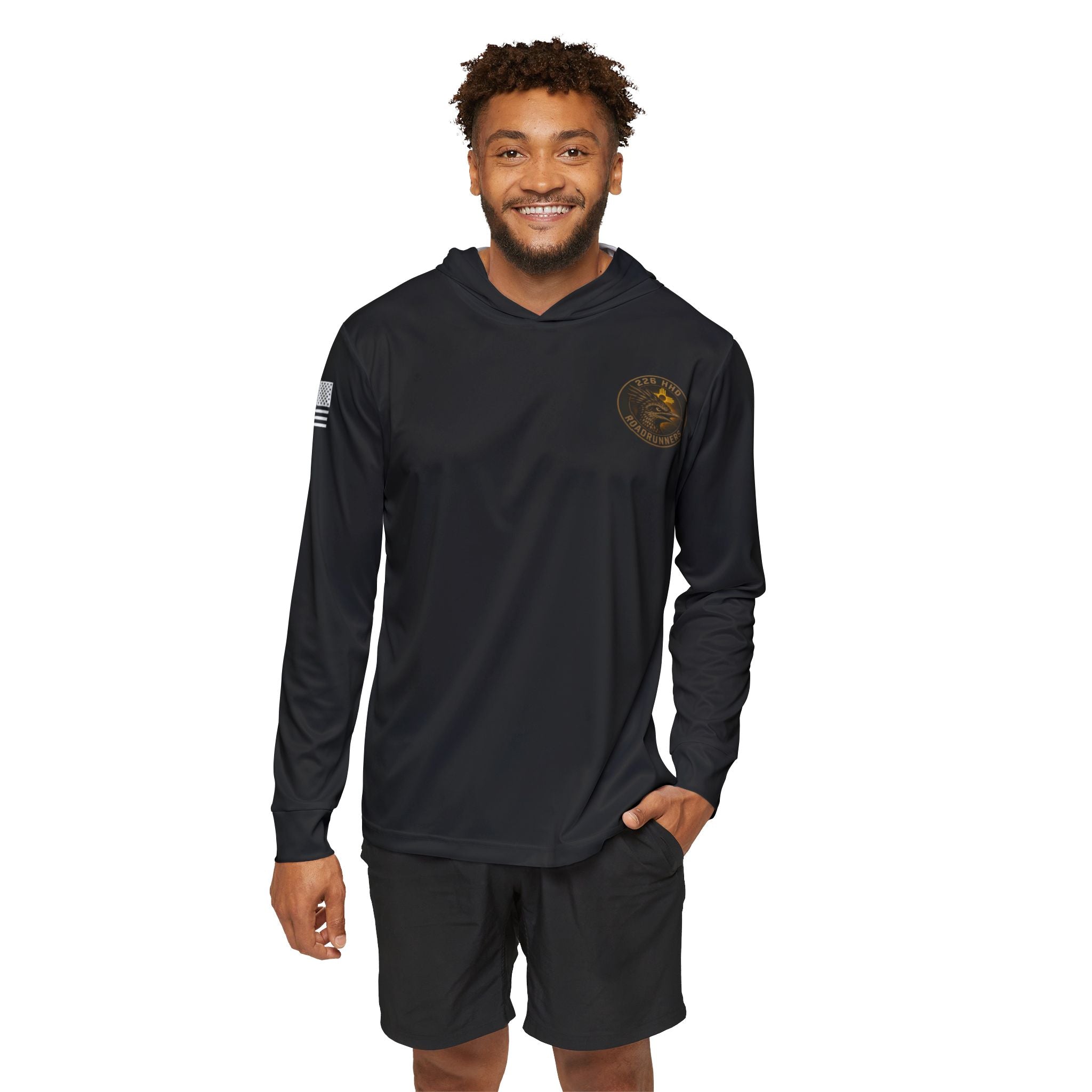 Black hoodie worn by man with front hood, chest emblem, long sleeves, and pocket