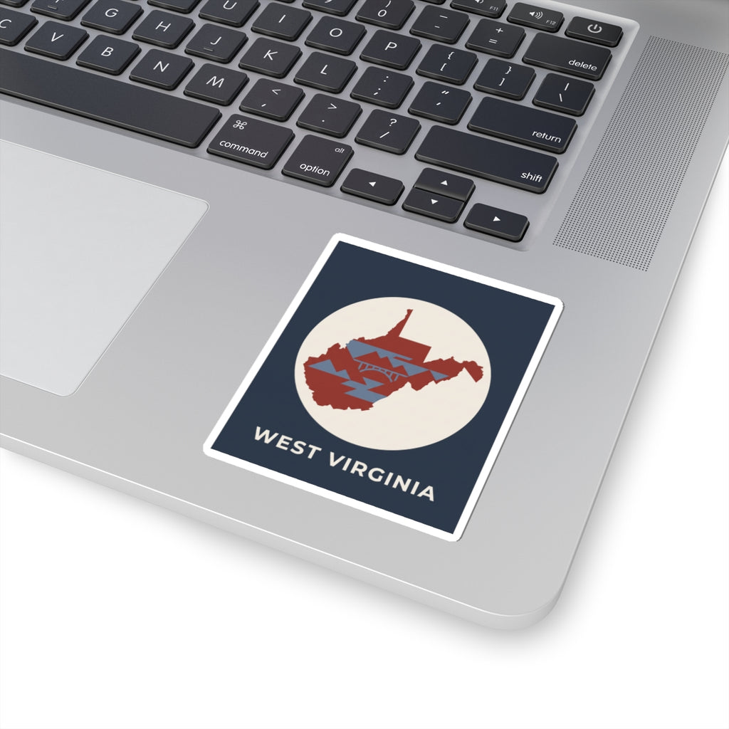 West Virginia map sticker on laptop keyboard, navy square with red state graphic and text