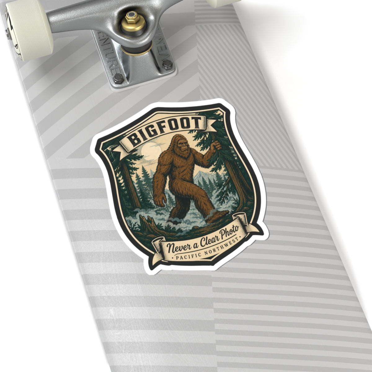 Bigfoot hiking badge sticker on notebook page, shield logo with brown Sasquatch