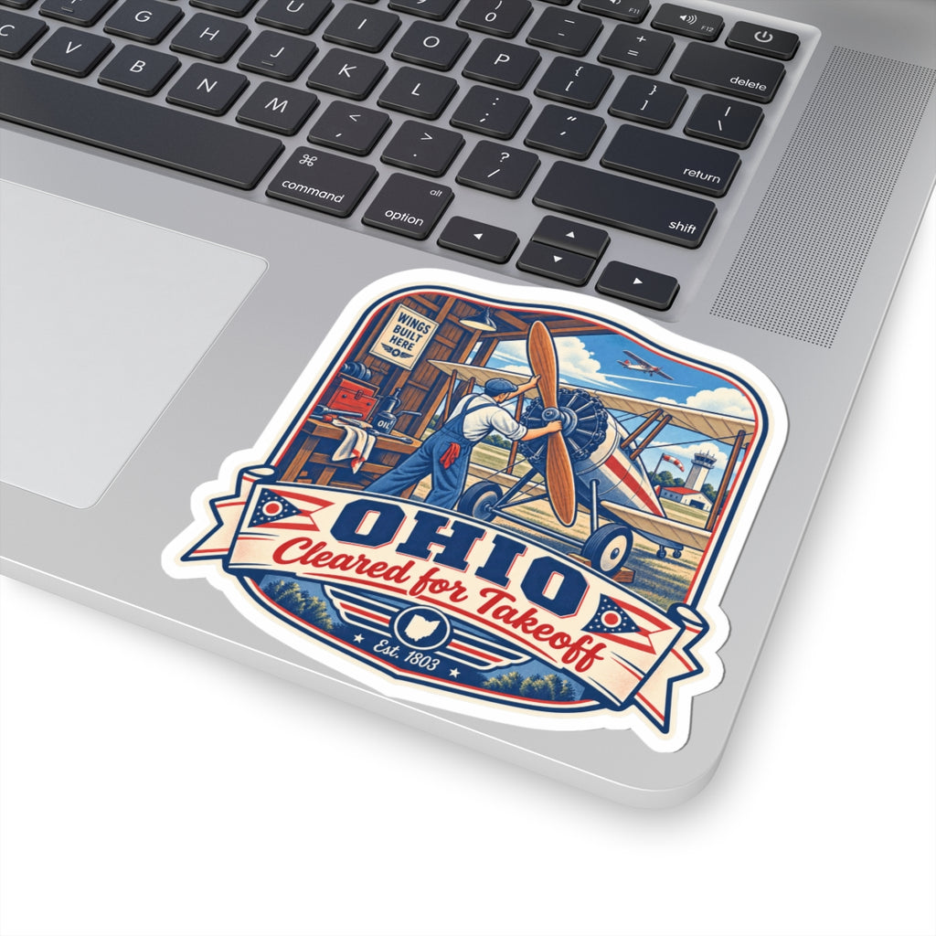 Die-cut biplane sticker showing pilot and aircraft, with "OHIO" and "Cleared for Takeoff"