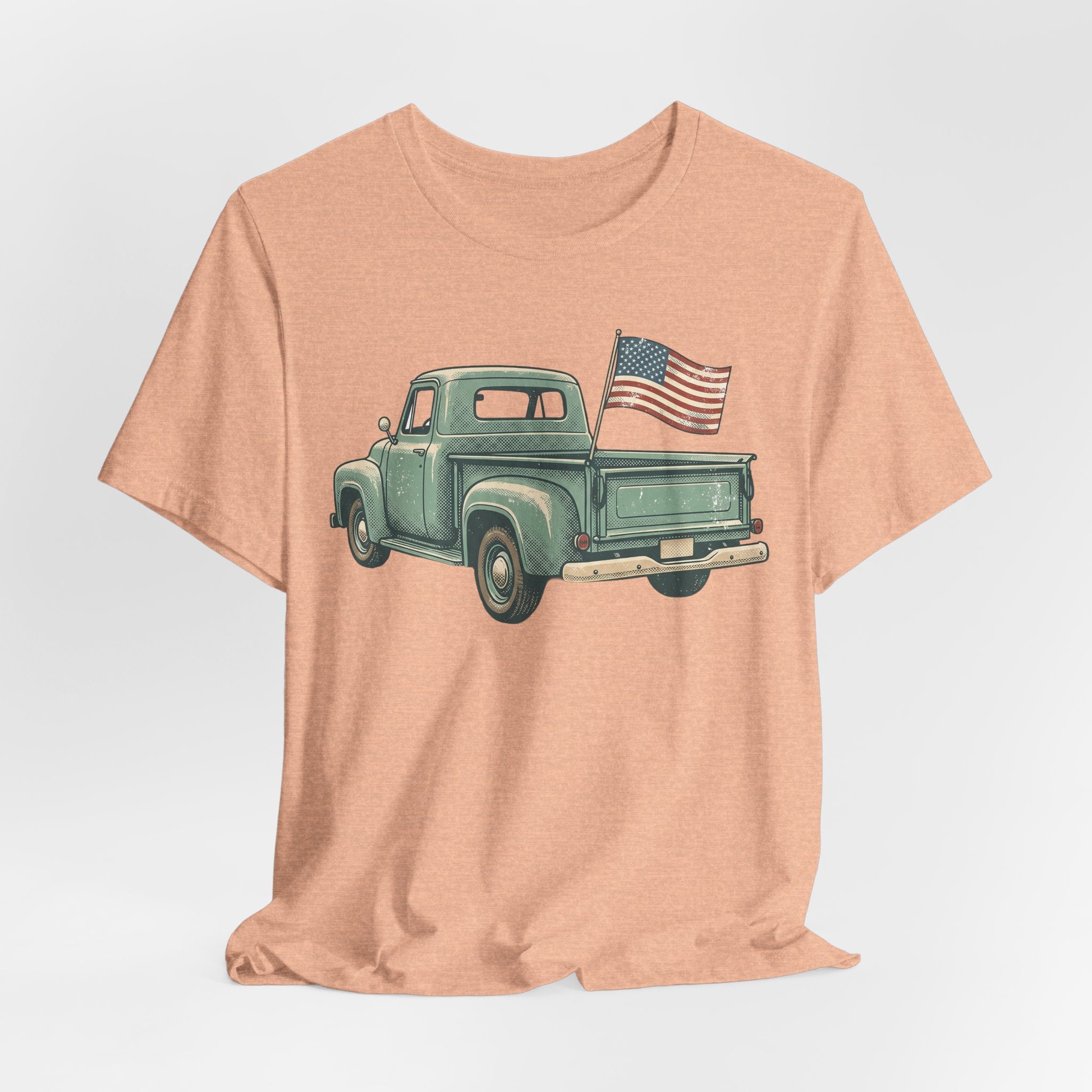 Peach T-shirt with green vintage pickup truck and U.S. flag graphic on front