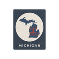 Michigan metal wall art sign in dark blue with circular map emblem and MICHIGAN text