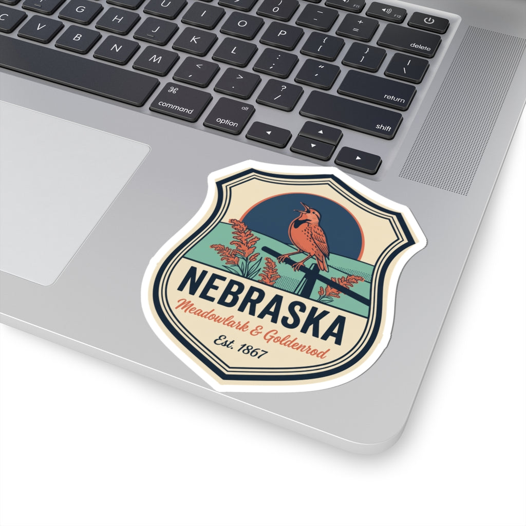Nebraska vintage badge sticker on a laptop, meadowlark illustration with goldenrod text