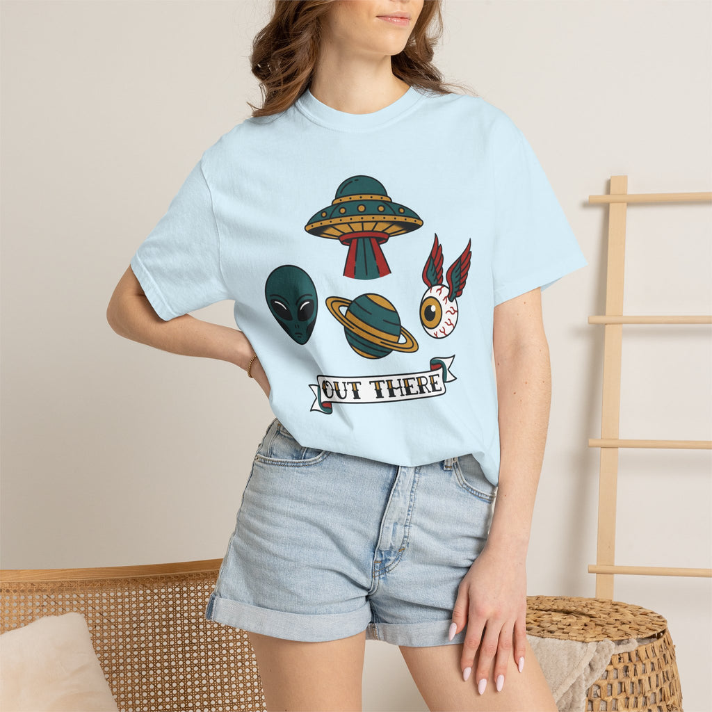 Light blue crewneck T-shirt with UFO and alien patch graphic, worn with denim shorts.