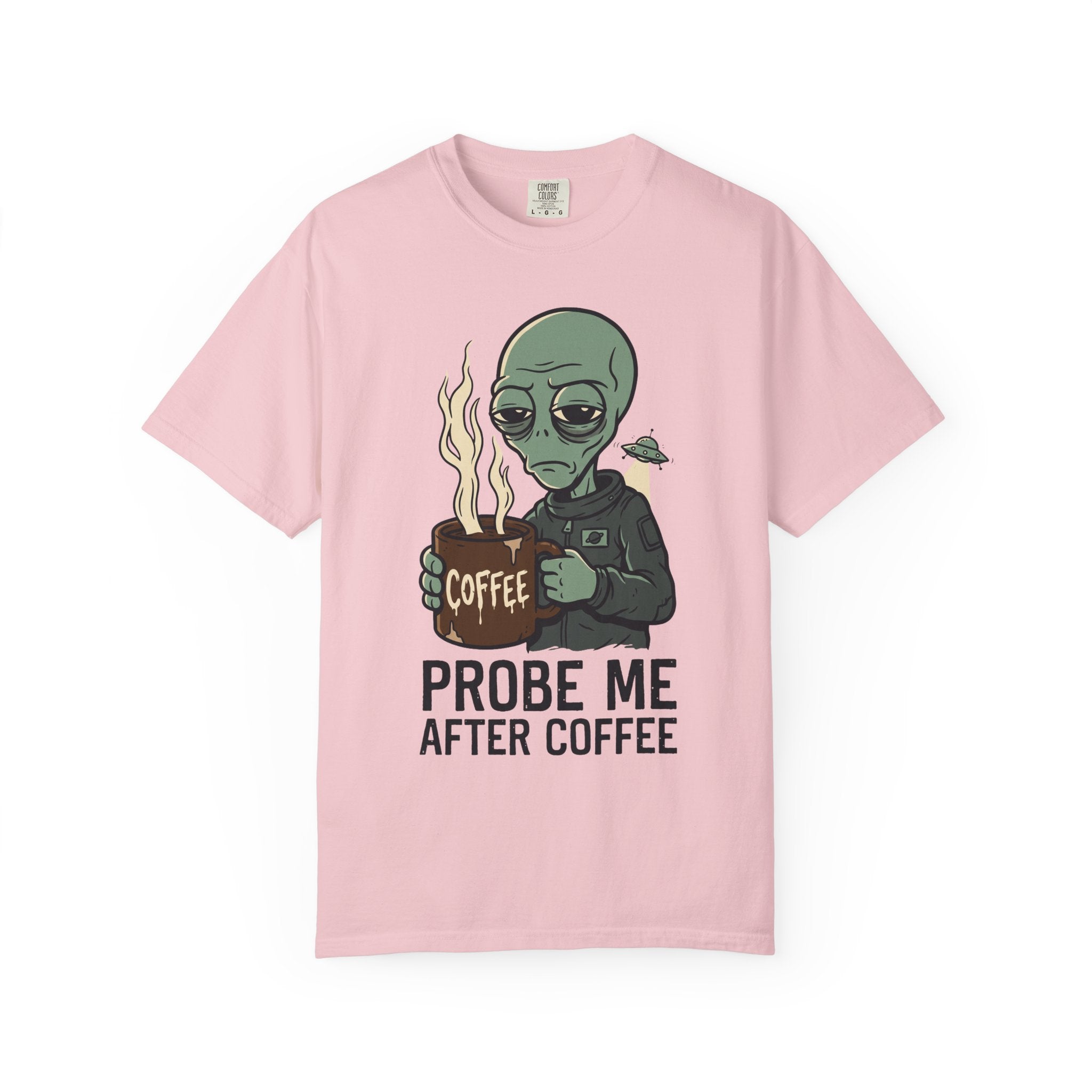 Pink T-shirt with green alien holding a coffee mug and “PROBE ME AFTER COFFEE” print