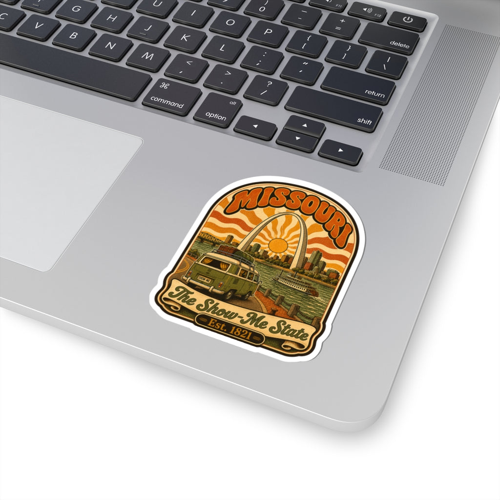 Missouri retro roadtrip sticker on laptop keyboard, arch sun over bus and riverboat