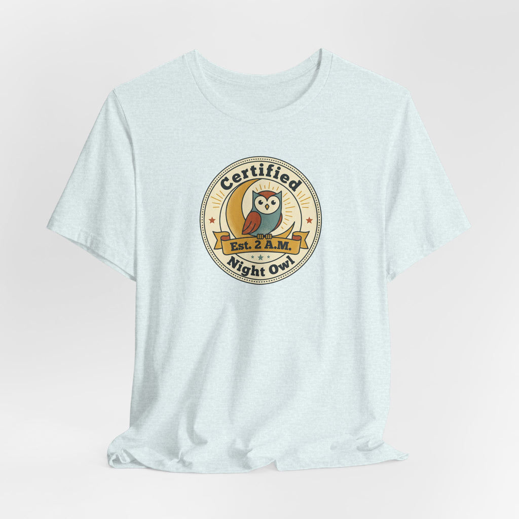 Light blue T-shirt with Certified Night Owl badge graphic on chest
