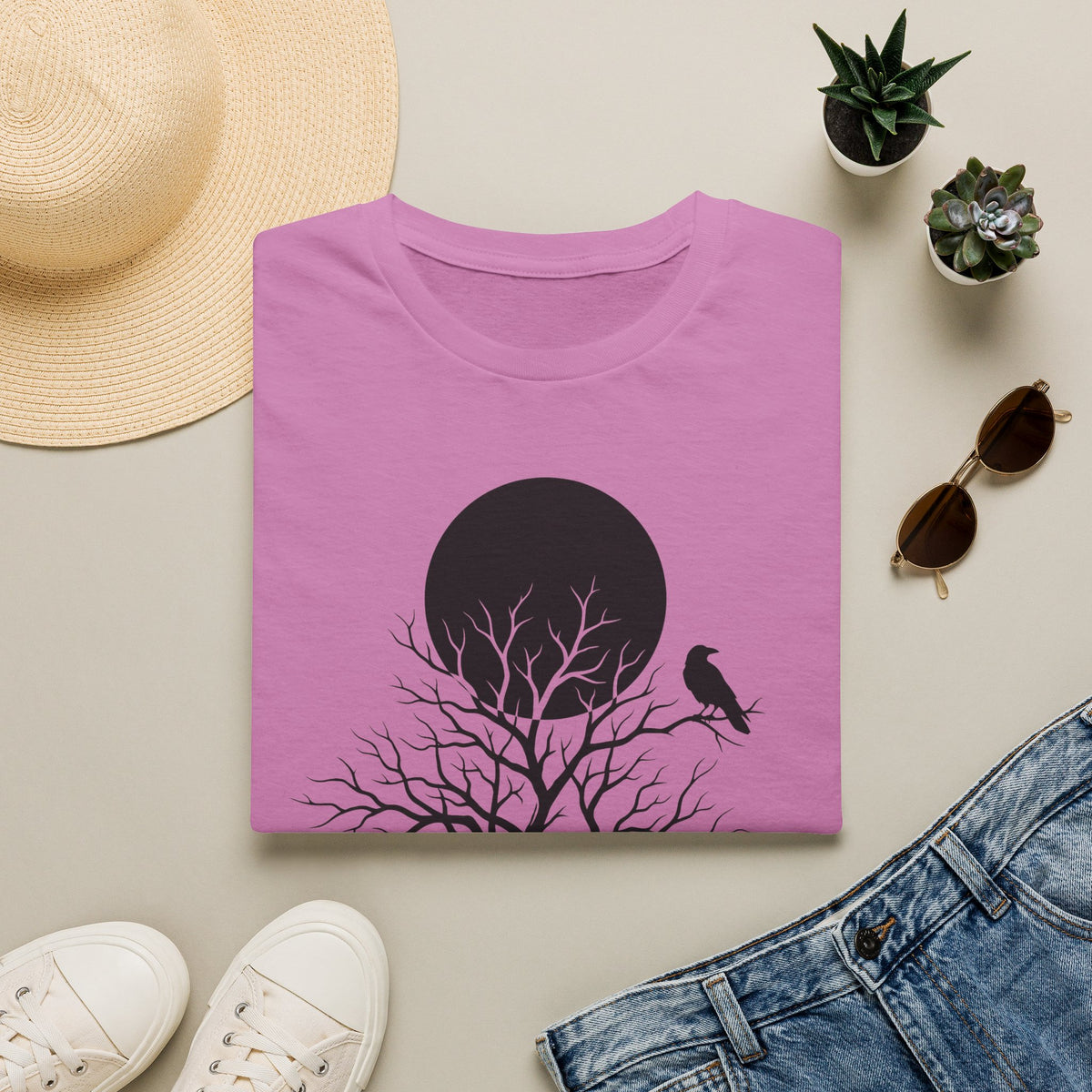 Pink t-shirt with black moon, leafless tree silhouette graphic, and crow on right