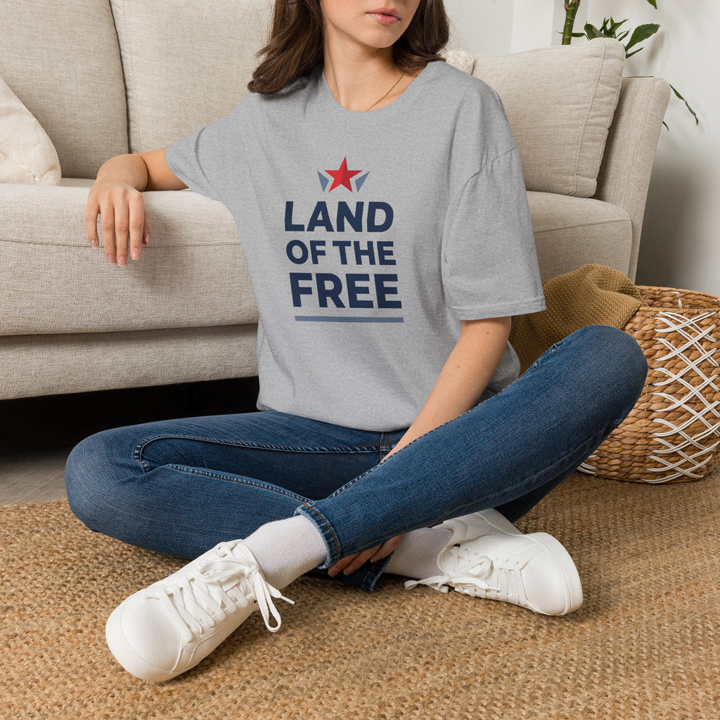 Light gray crewneck T-shirt worn by model with red star and blue "LAND OF THE FREE" print