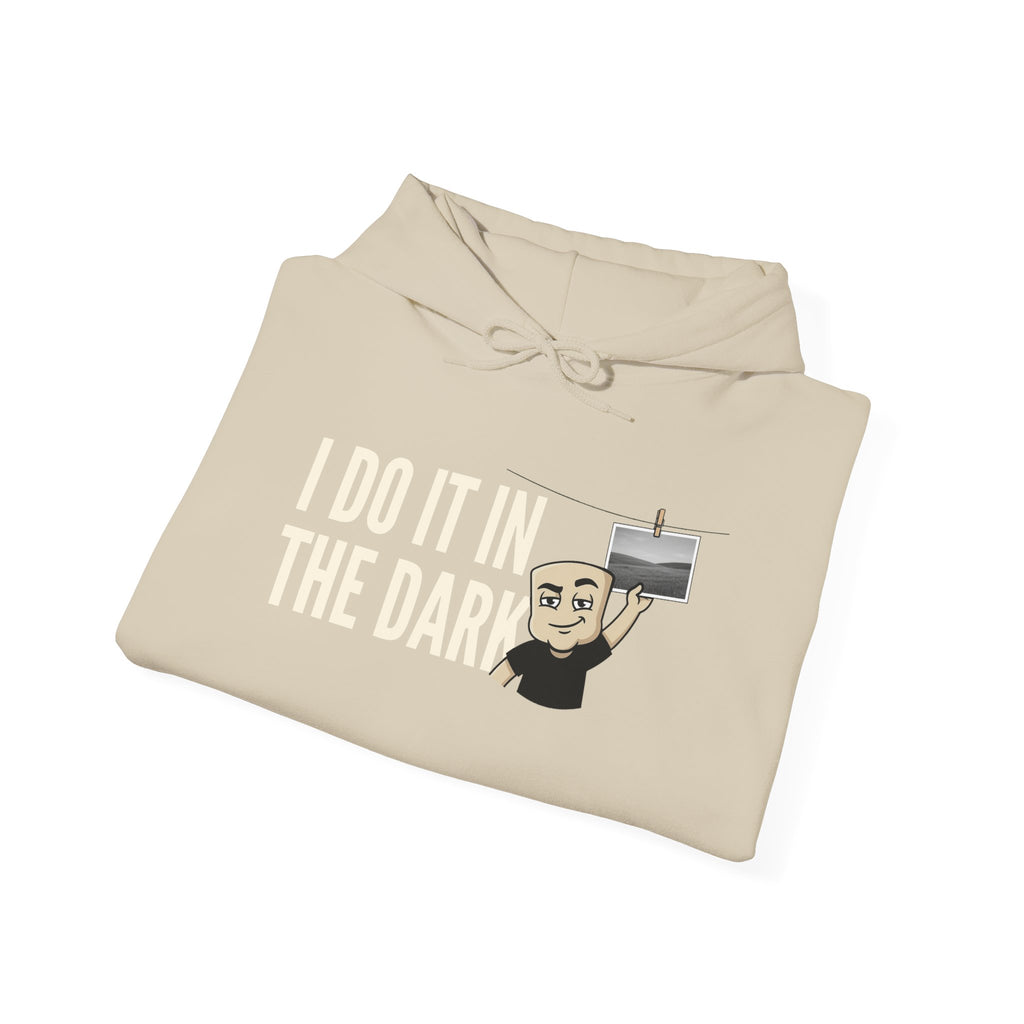 Cream hoodie with drawstring hood and “I DO IT IN THE DARK” graphic on front