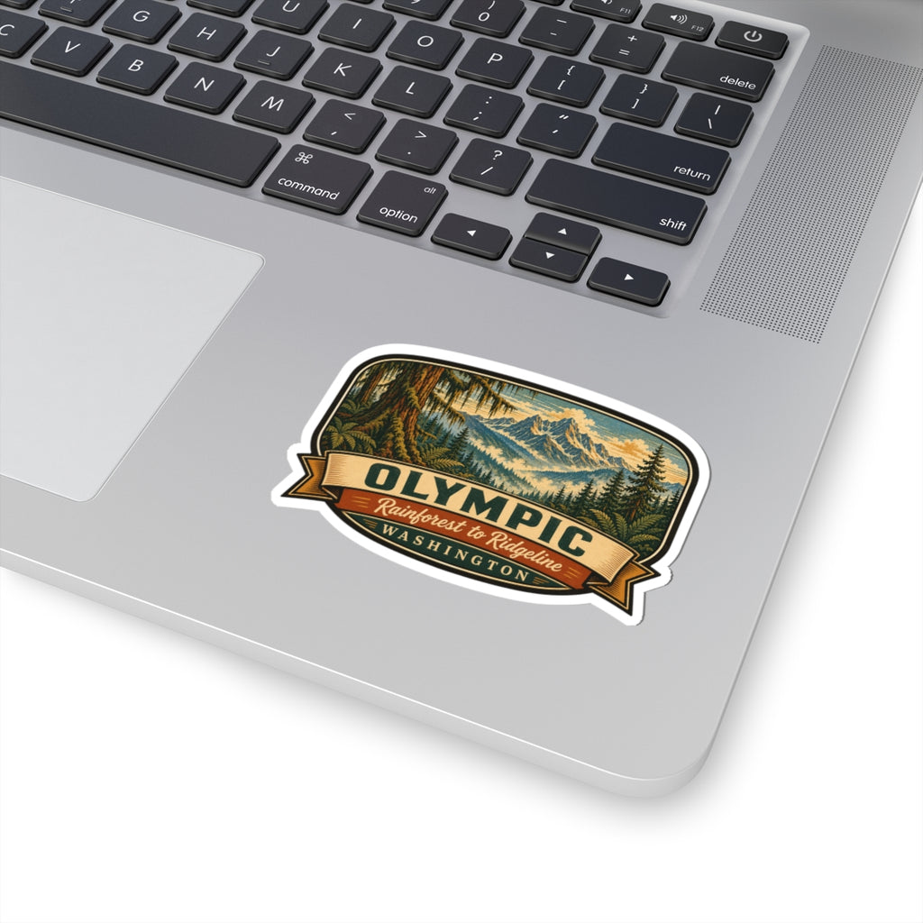 Olympic Washington travel sticker on laptop lid, showing mountain forest graphic and ribbon text