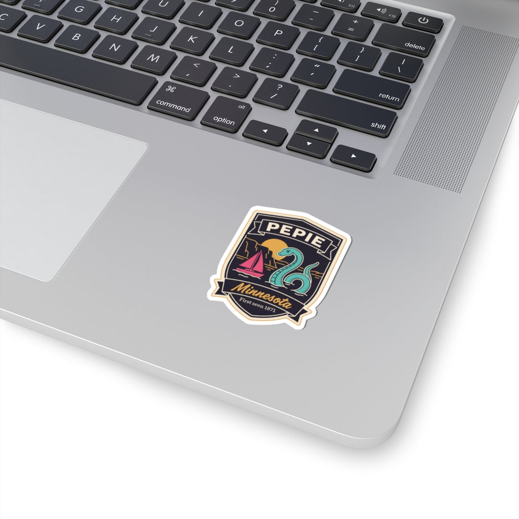 Kiss-cut vinyl sticker badge with PEPIE text and lake monster illustration in dark colors