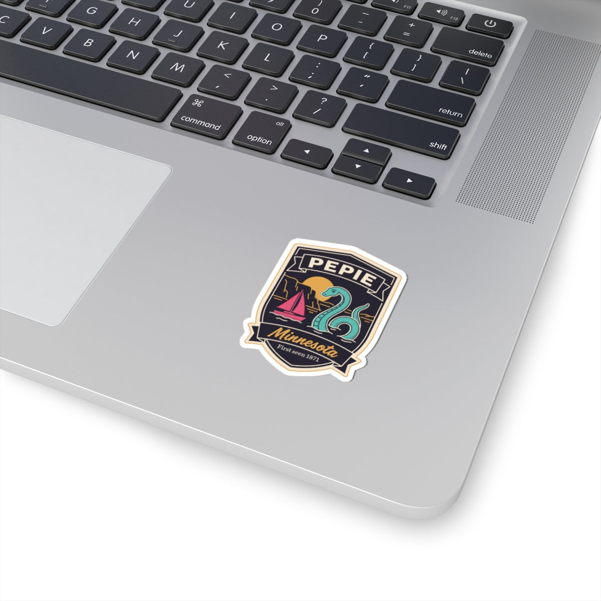 Kiss-cut vinyl sticker badge with PEPIE text and lake monster illustration in dark colors
