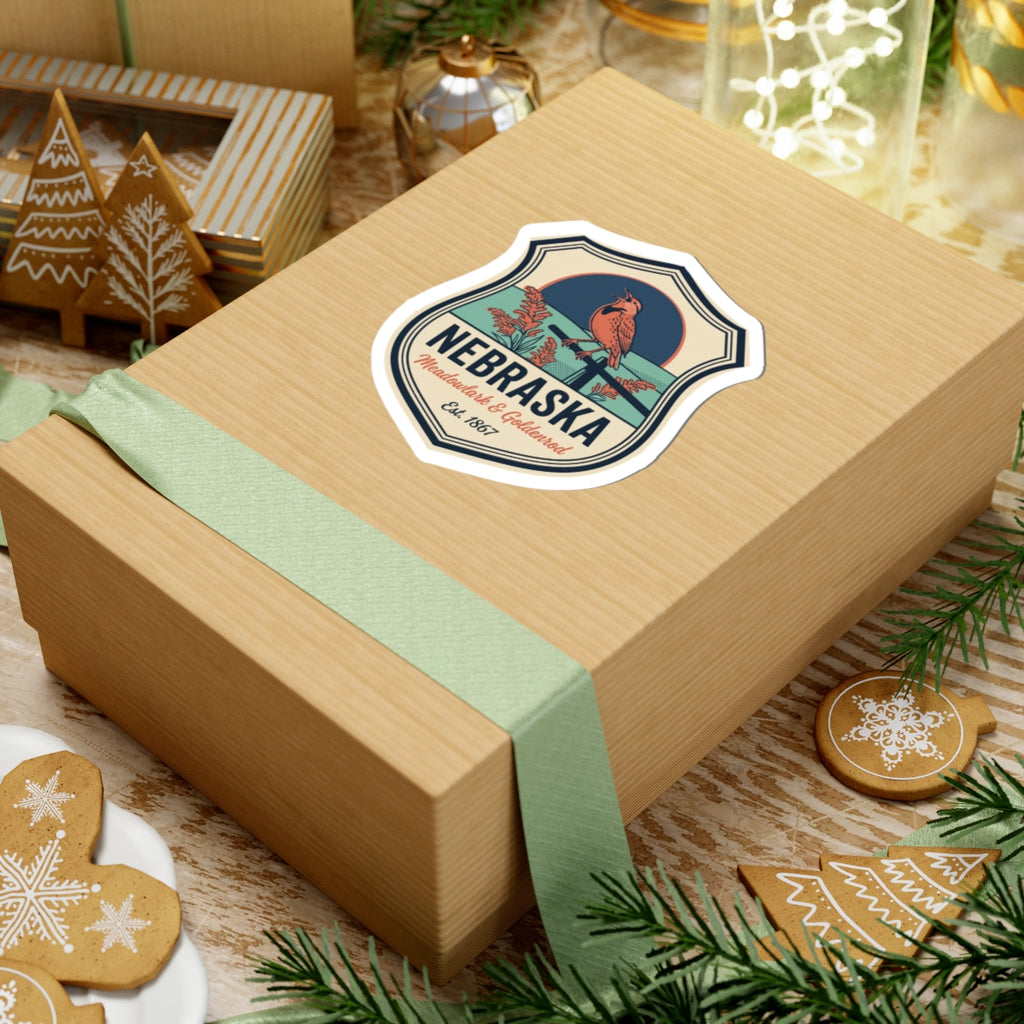 Nebraska badge sticker on a gift box with meadowlark & goldenrod artwork