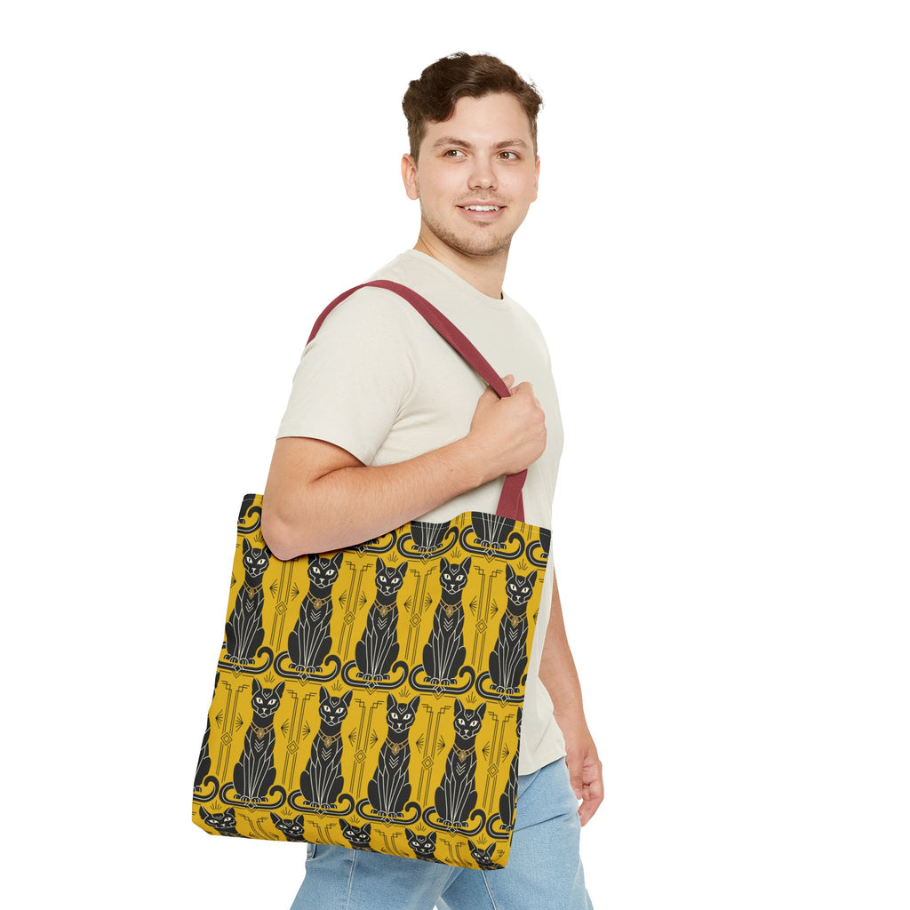 Yellow cat-pattern tote bag with black cats and navy swirls, red-brown shoulder strap.