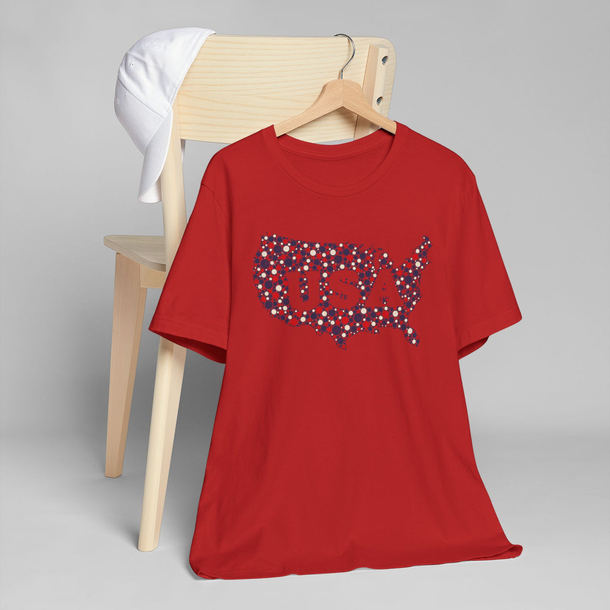 Red crew-neck T-shirt with dotted U.S. map graphic in blue and red dots.